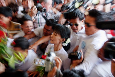 Myanmar's pro-democracy leader Aung San Suu Kyi makes her way trough the crowd as she arrives to the office of her National League for Democracy (NLD) in Yangon