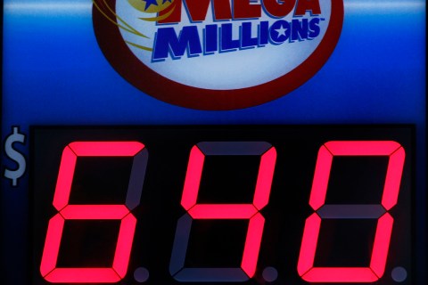 A storefront sign displays the jackpot total of Friday's Mega Millions lottery in Hoboken, New Jersey
