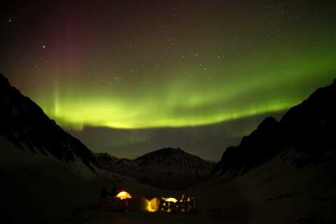The aurora borealis is seen over campers in the snow in Chugach mountain range, outside the town of Valdez, east of Anchorage