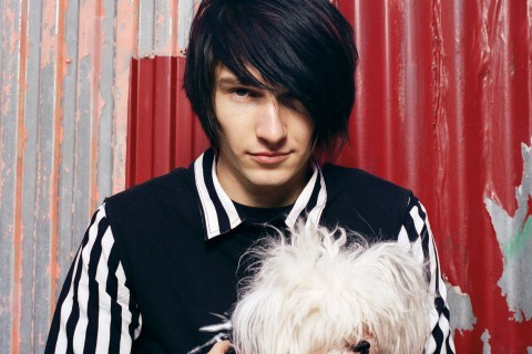 Young man with dog, emo haircut