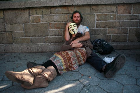 Occupy Wall Street activists rest on a sidewalk during a May Day demonstration in New York