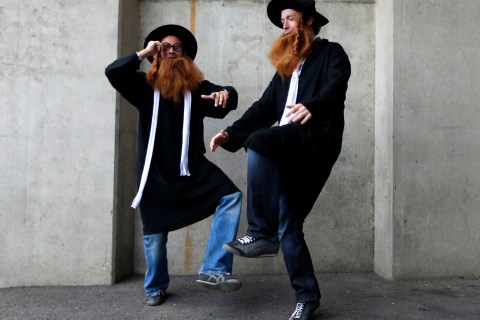 Spectators wearing Rabbi costumes pose for photographs during the Sevens World Series at Twickenham Stadium in London