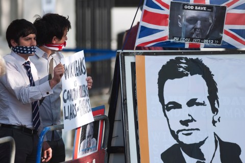 Protesters supporting Wikileaks founder Julian Assange hold placards outside the Supreme Court in London