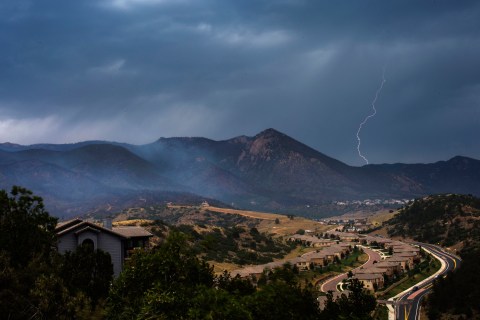 Lighting strikes as rain clouds approach the Waldo Canyon fire in Colorado Springs, Colorado