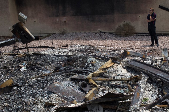 A man stands beside a home leveled by the Waldo Canyon fire in Colorado Springs