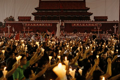 People take part in candlelight vigil in Hong Kong on 23rd anniversary of Tiananmen crackdown
