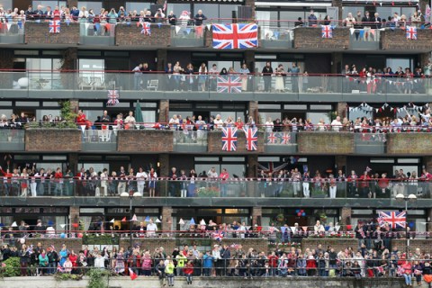 Revellers line the route of  the Diamond Jubilee River Pageant along the River Thames in London