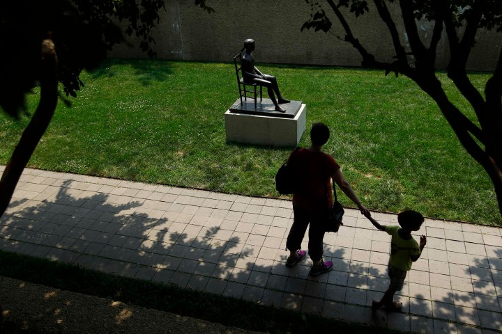 A woman and child walk through the Smithsonian Institution's Hirshhorn Sculpture Garden in Washington