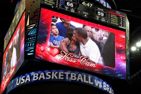 U.S. President Obama and first lady Michelle Obama are shown kissing on the "Kiss Cam" screen during a timeout in the Olympic basketball exhibition game between the U.S. and Brazil national men's teams in Washington