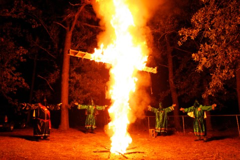 Members of the KKK participate in a cross lighting ceremony at a Klansman's home in Warrenville, South Carolina