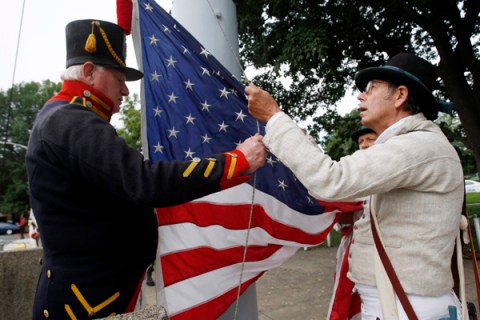 3) Reenactors from the 1812 Marine Guard raise the American flag in the Charlestown Navy Yard as they commemorate the 200th anniversary of the USS Constitution's victory over HMS Guerriere in Charlestown