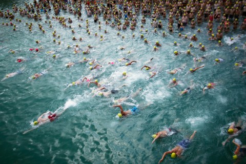 People swim at start of annual Lake Zurich crossing swimming event in Zurich