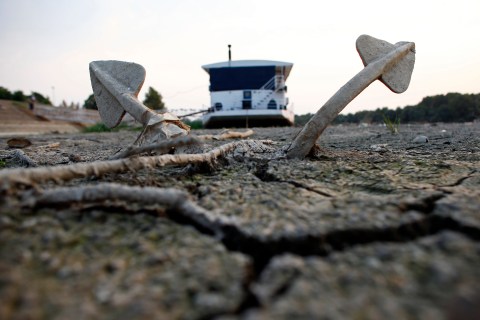 A boat and its anchor are stuck on the dry riverbed of the drought-stricken Danube river in Belgrade