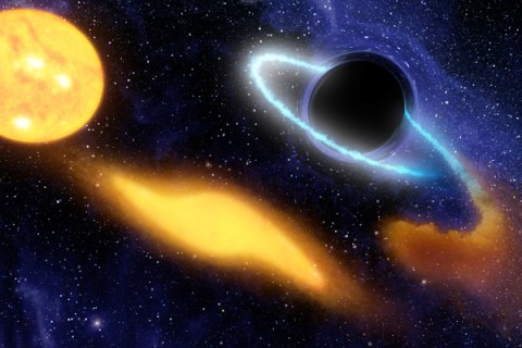 An artist's concept shows a supermassive black hole at the center of a remote galaxy digesting the remnants of a star