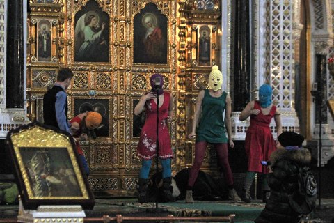 image: Russian radical feminist group Pussy Riot try to perform at the Christ the Saviour Cathedral in Moscow, Feb. 21, 2012.