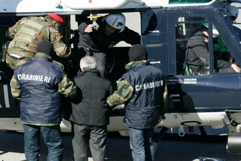 Officers of Italy's Carabiniere escort suspected 'Ndrangheta crime syndicate boss Condello into a waiting helicopter in Reggio Calabria