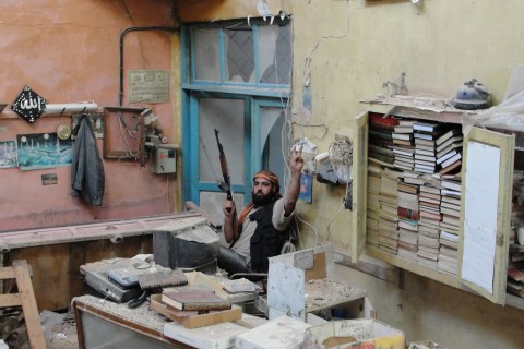 A member of the Free Syrian Army poses in the old city of Homs