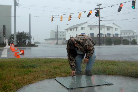 An employee from the sewer authority check pumps meant to keep rising sea water from clogging the system as Hurricane Sandy bears down on Dewey Beach