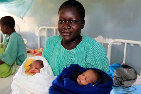 Owuor carries her newly born twin boys named after Obama and Romney in Siaya