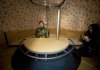 Image: Liu Qiyuan and his daughter sit inside one of his seven survival pods, December 11, 2012.