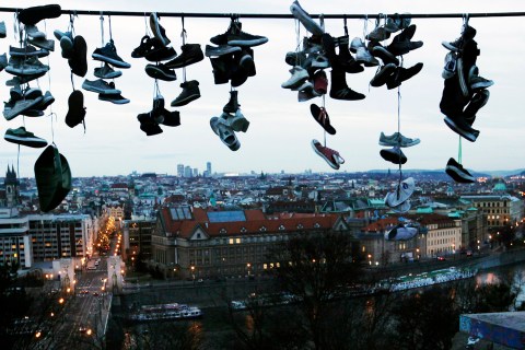 Shoes hang on power line at Letna park overlooking Prague