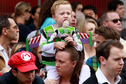 A boy dressed as Buzz Lightyear waits at the premiere of Disney and Pixar's "Toy Story 3" at Leicester Square in London