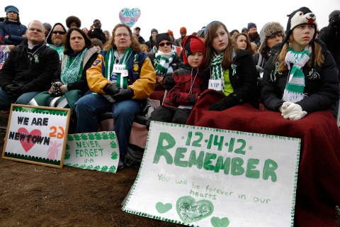 Participants from Newtown, Connecticut, wearing the green and white colors of Sandy Hook Elementary School, sit in the front rows during the March on Washington for Gun Control on the National Mall in Washington