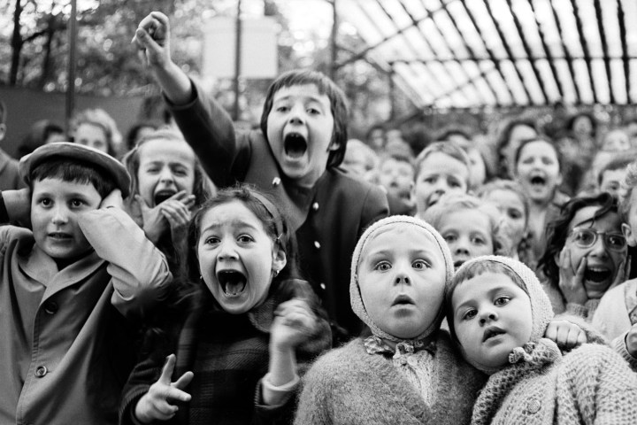 Children watch the story of "Saint George and the Dragon" at an outdoor puppet theater in Paris, 1963.