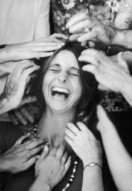 A woman roars with laughter as she undergoes a head-tapping session, part of a sensory awareness class at the Esalen Institute in Big Sur, Calif., on Oct. 1, 1970.
