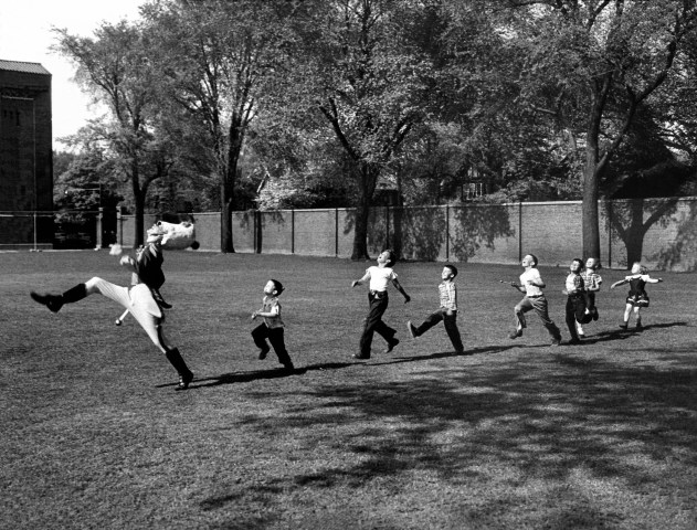 A drum major for the University of Michigan marching band leads a line of children, in Ann Arbor, Mich., in 1950.