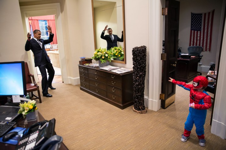 U.S. President Barack Obama pretends to be caught in Spider-Man's web as he greets Nicholas Tamarin, 3, just outside the Oval Office in Washington, D.C., on Oct. 26, 2012.