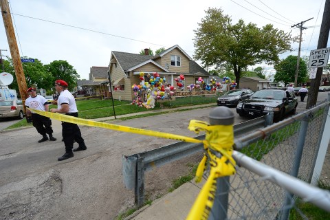 A police car and members of the Guardian Angels stand in front of Gina DeJesus's family's home in Cleveland, on May 8, 2013.