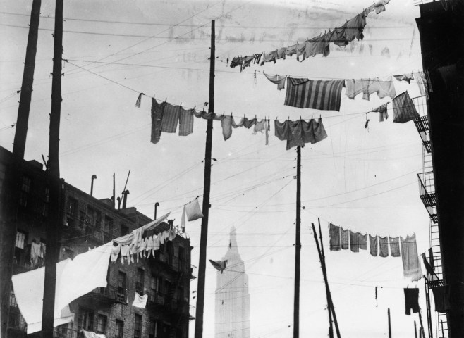 The Empire State Building appears through clotheslines hung in New York City, circa 1935.