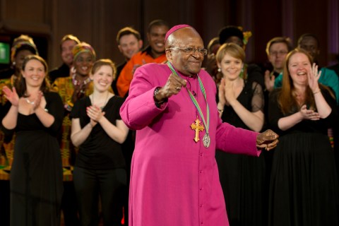 The former Anglican archbishop of Cape Town Desmond Tutu dances after receiving the 2013 Templeton Prize at the Guildhall in central London