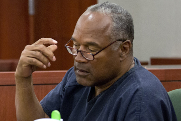 O.J. Simpson removes his glasses as he testifies during an evidentiary hearing in Clark County District Court in Las Vegas