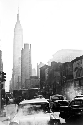 Cars steam in traffic below the Empire State Building in New York City, in 1955.