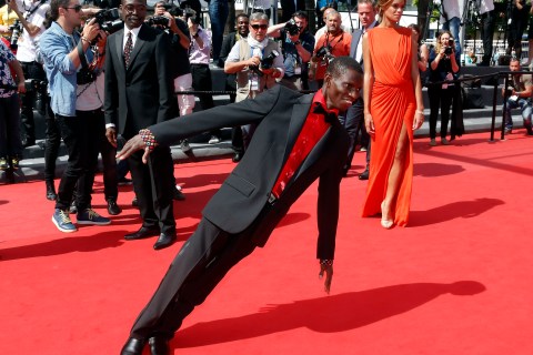 Cast member Souleymane Deme performs on the red carpet as he arrives for the screening of the film "Grigris" in competition during the 66th Cannes Film Festival