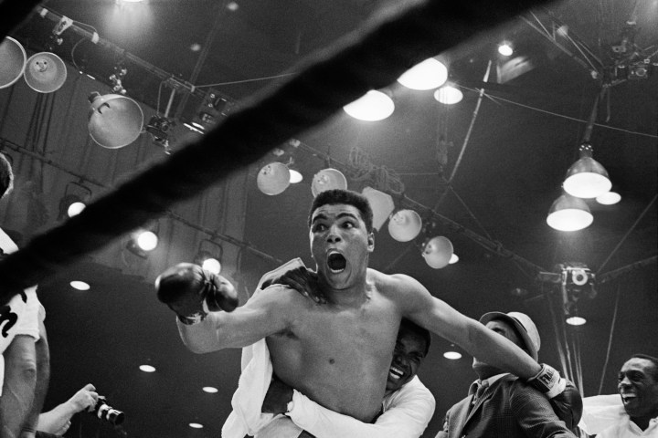 Cassius Clay defeats Sonny Liston for the heavyweight boxing title in Miami Beach, on Feb. 25, 1964. 