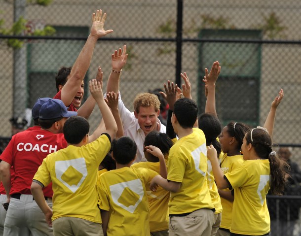 Prince Harry participates in baseball drills with Harlem RBI's youth on the Field of Dreams during a visit to Harlem RBI in New York City, on May 14, 2013.