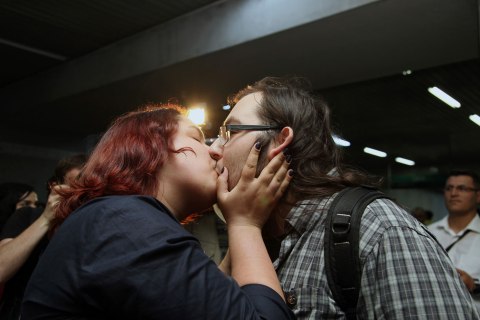 A young Turkish couple kiss to protest against subway official's harassment of a couple for kissing in public last week, inside a subway stop in Ankara, Turkey, Saturday, May 25, 2013.