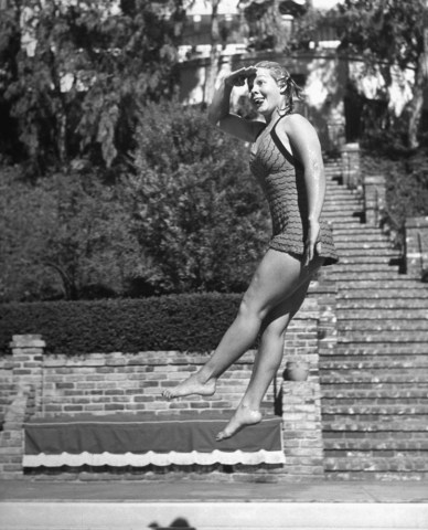Starlet June Preisser jumping into swimming pool.