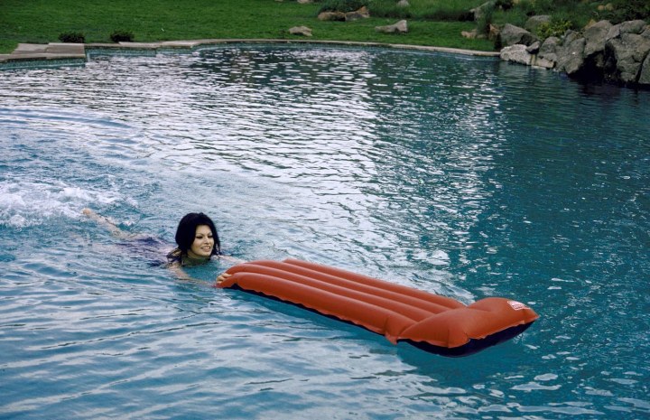 Sophia Loren swimming in pool at her villa.