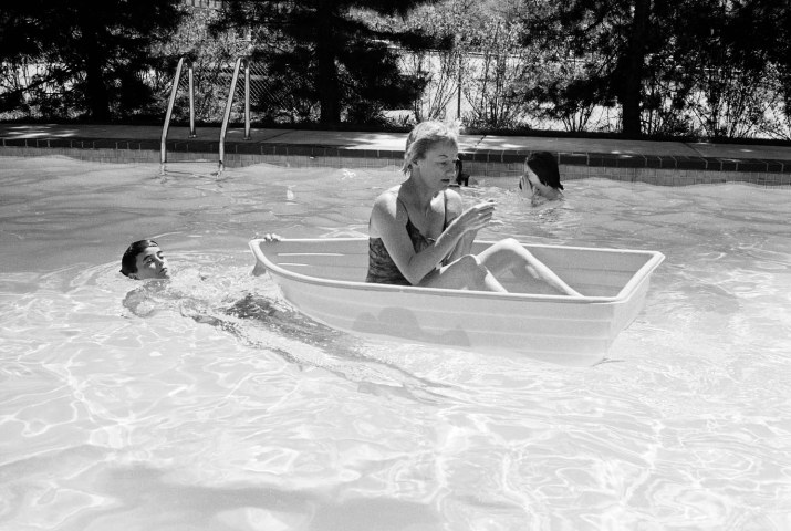 Comedian Phyllis Diller with some of her children in their backyard swimming pool.