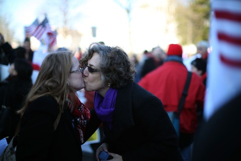 From left: Andrea Grill and Lee Ann Hopkins, from Alexandria, Va. kiss after becoming engaged during a rally outside of the U.S Supreme Court in Washington, D.C., on March 26, 2013.
