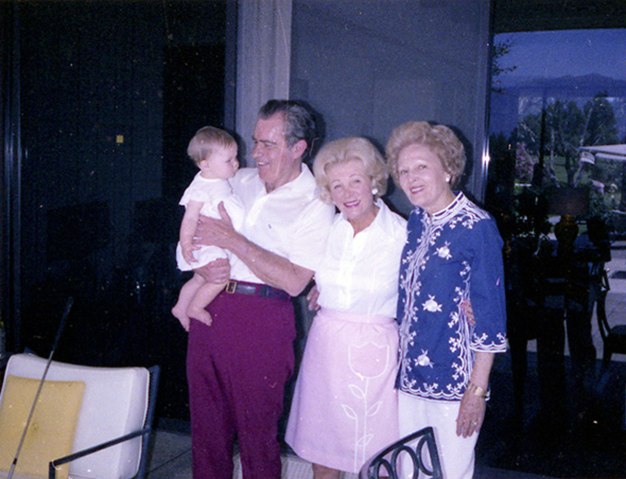 28_Sunnylands-Press-Photos_NixonsaPresident Nixon holding granddaughter Jenny Eisenhower with Leonore Annenberg and Pat Nixon outside the Game Room, April 1979.