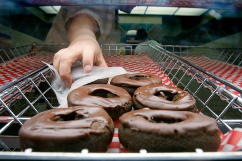 A Tim Hortons employee grabs a doughnut for a customer at the Pengrowth Saddledome in Calgary