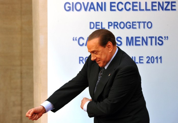 Former Italian Prime Minister Silvio Berlusconi dances during an award ceremony for youth called "Campus Mentis" in Rome, on April 8, 2011.