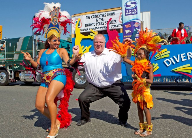 Toronto Mayor Rob Ford dances with participants at the Toronto Caribbean Carnival in Toronto, on July 30, 2011.