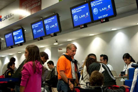 Travellers stand to check in at the Lan airlines counter at the Cancun International Airport, on Feb. 28, 2010.