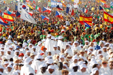 Pilgrims attend a mass led by Pope Benedict XVI at the Cuatro Vientos aerodrome as part of World Youth Day festivities in Madrid